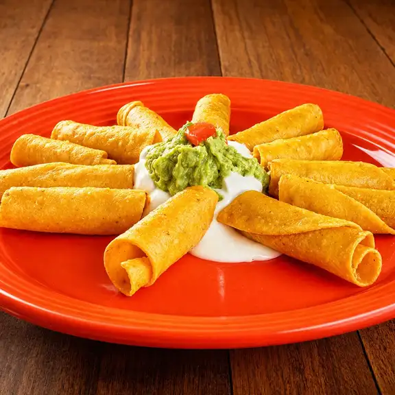 Rolled taquitos served with guacamole and sour cream dip at Javier's Authentic Mexican Food Los Angeles CA